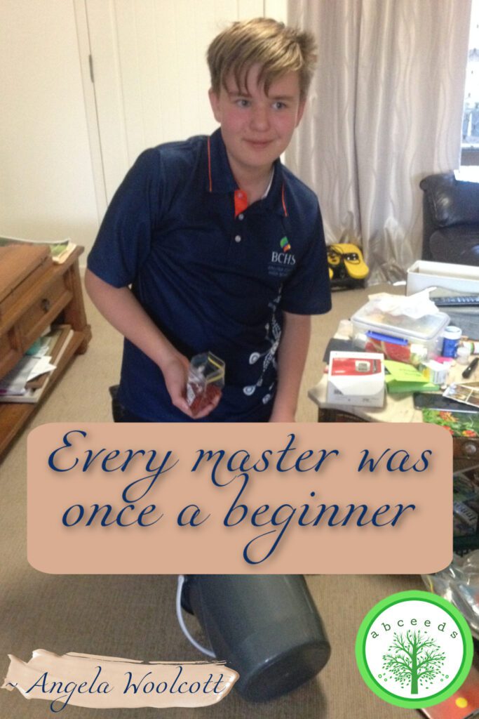 Photo of Toby Woolcott holding his first seed packet, with an inspirational quote 'Every master was once a beginner.'
